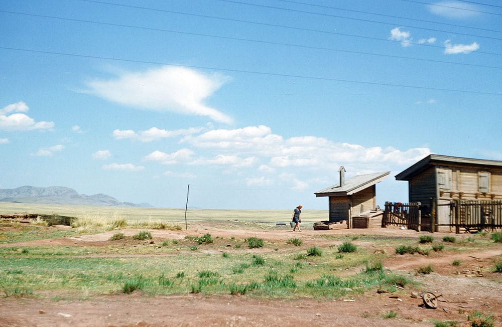 A woman returning from the fields, unknown location.