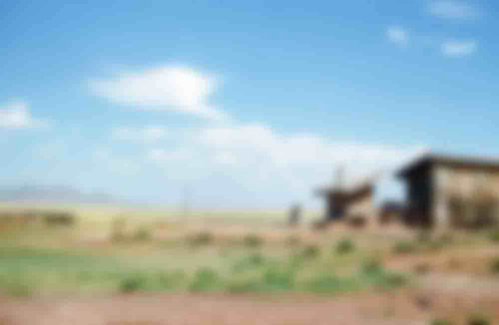 A woman returning from the fields, unknown location.