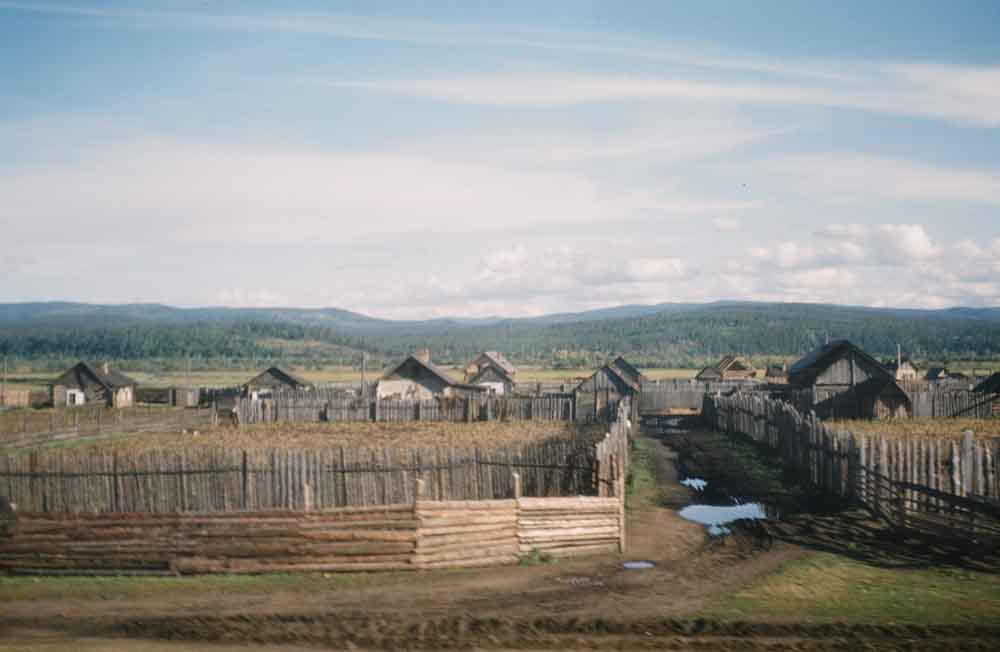 'Worn mountains' and wooden houses, location unknown.