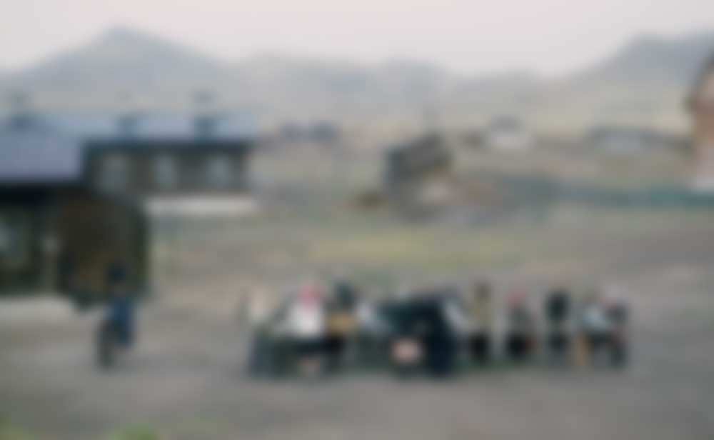 Head-scarfed women gather around a communal table.