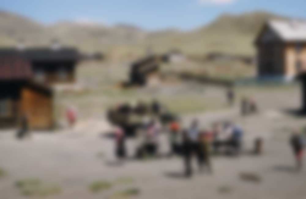 Head-scarfed women gather around a communal table.